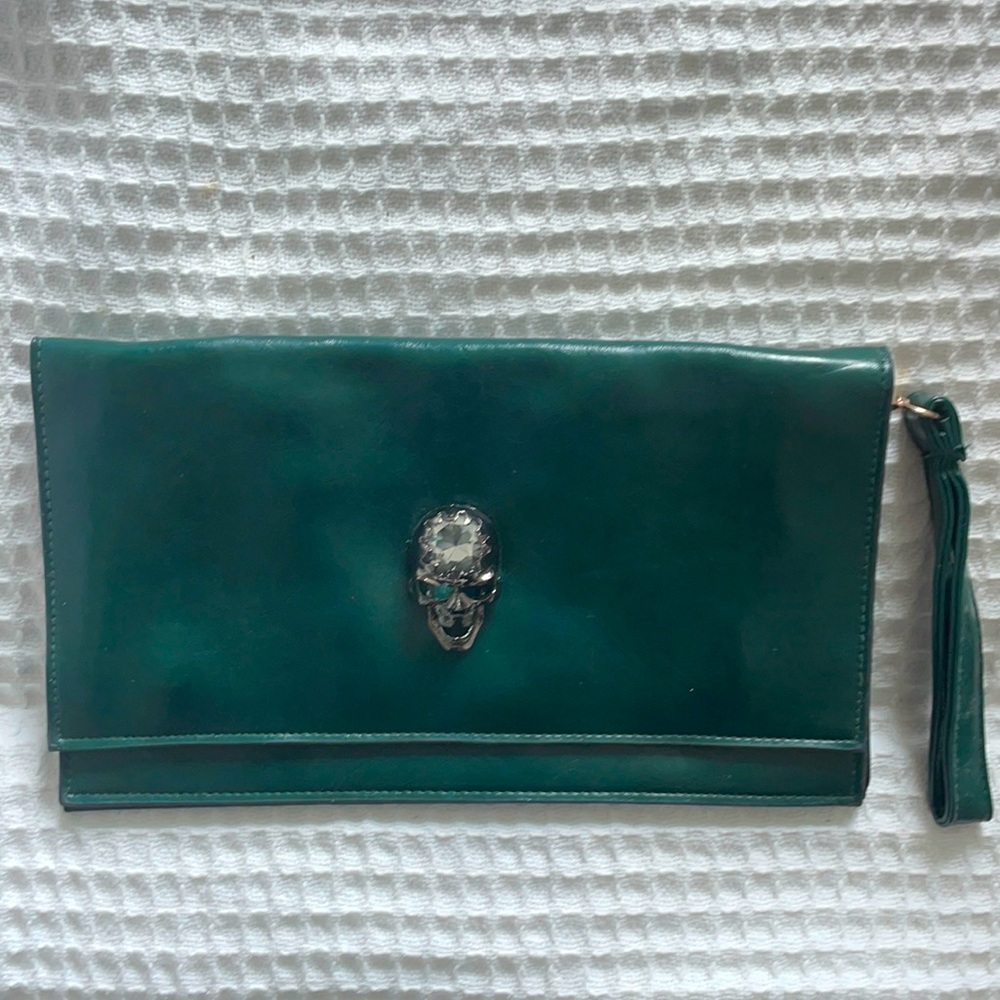 Emerald green leather purse with a diamond like skull